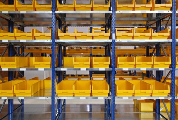 Bright yellow empty storage bins neatly organized in warehouse