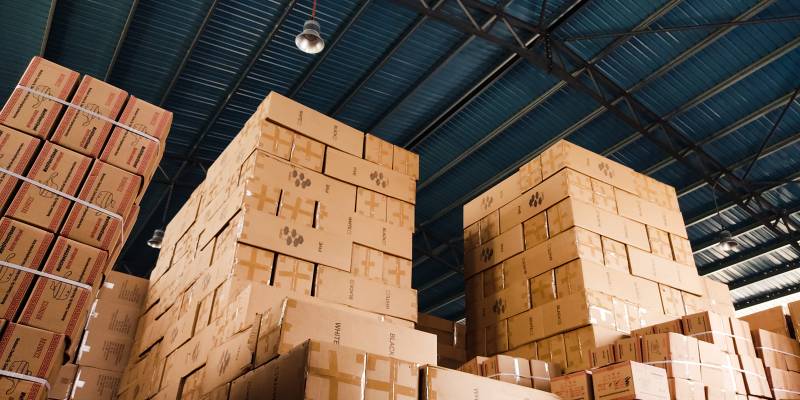 Boxes piled to the ceiling of a warehouse