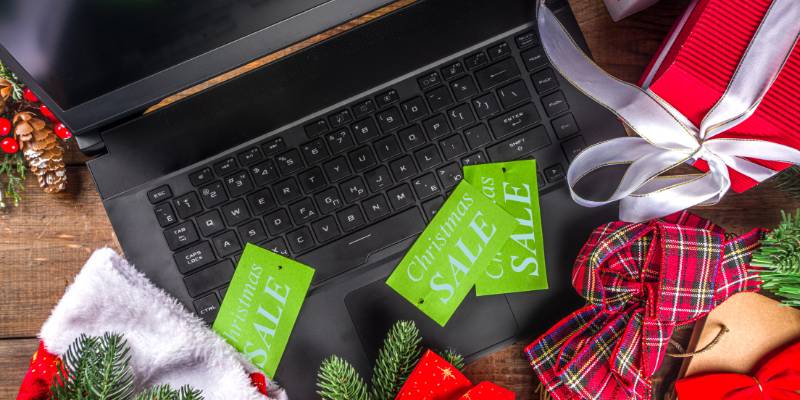 Laptop littered with holiday sale items