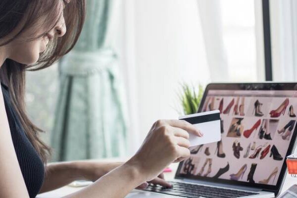 Woman using her credit card to shop online