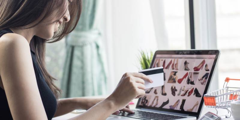 Woman using her credit card to shop online