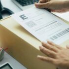 placing a priority mail label on a box for shipping to a customer