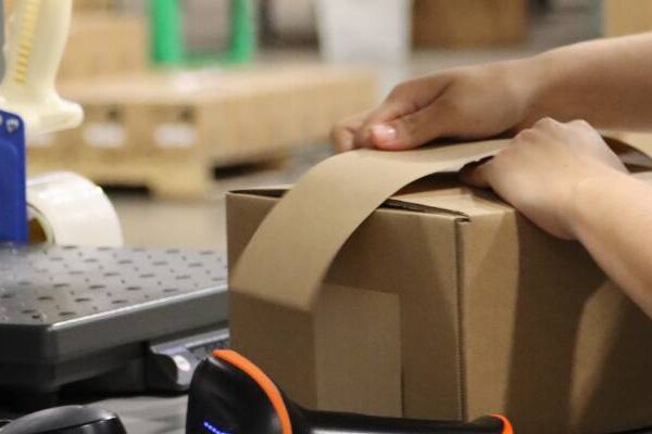 Packing a box in the warehouse to fulfill a Shopify order