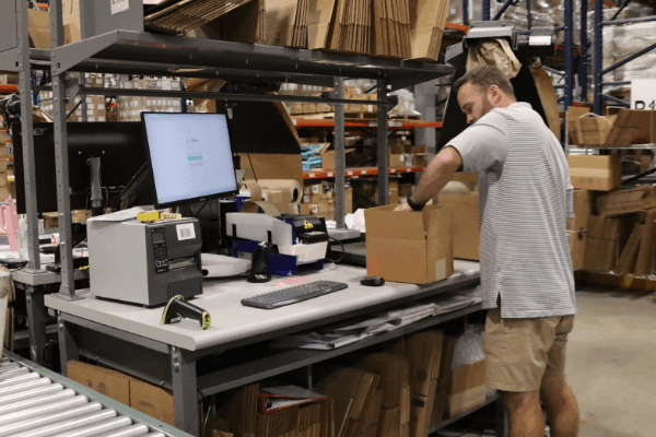 Warehouse worker packing an order for immediate shipping